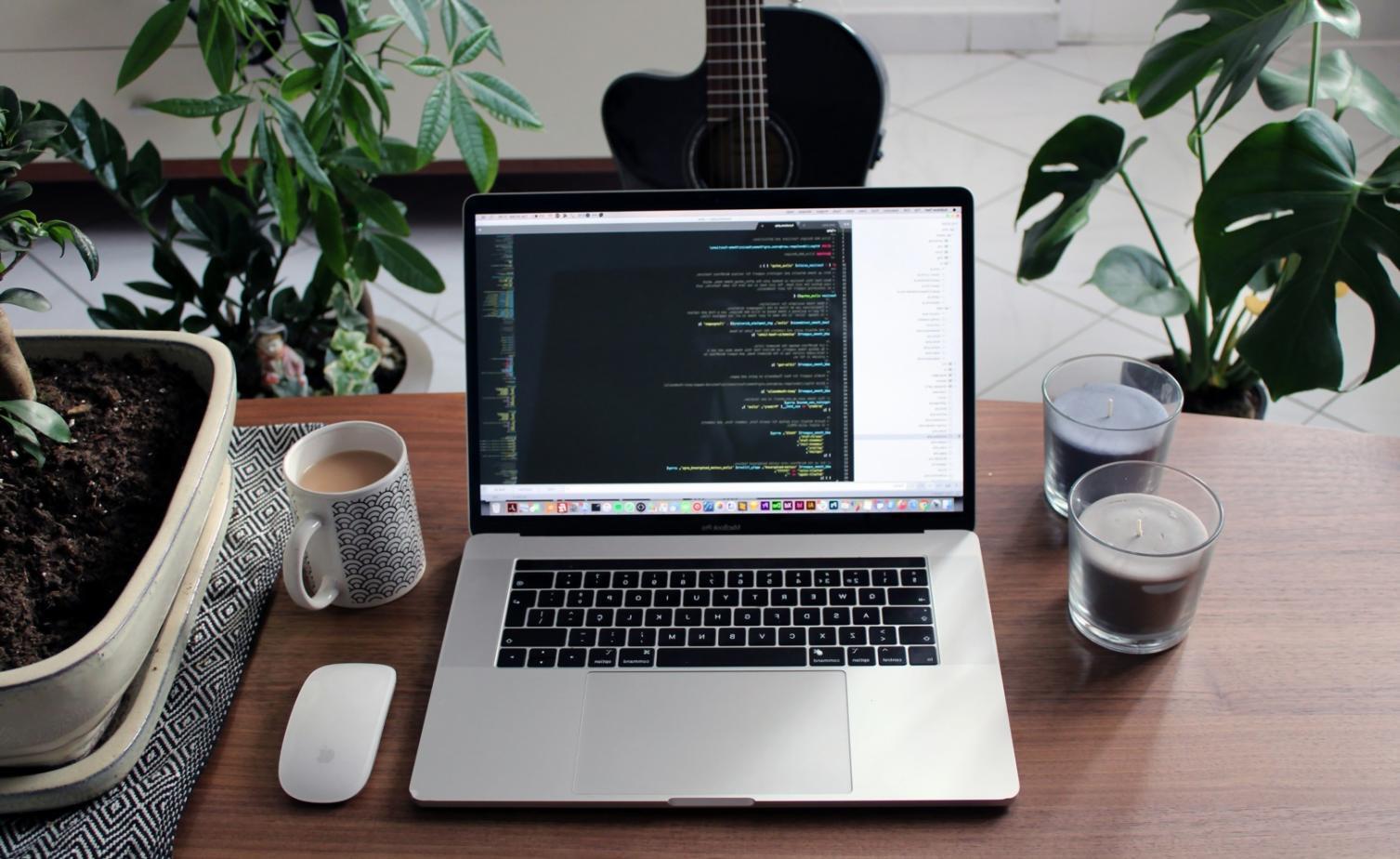 Professional team collaborating on interface design review session with multiple screens showing design systems